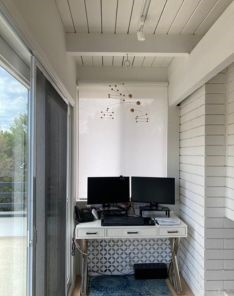 Roller shades for windows installed in a Mission Viejo condo office area, showcasing custom pull down window shades with modern decor.