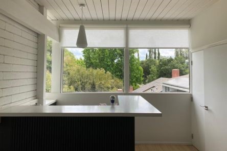 Close-up of roller shades installation in a Mission Viejo condo, highlighting the clean and functional design of custom window shades.
