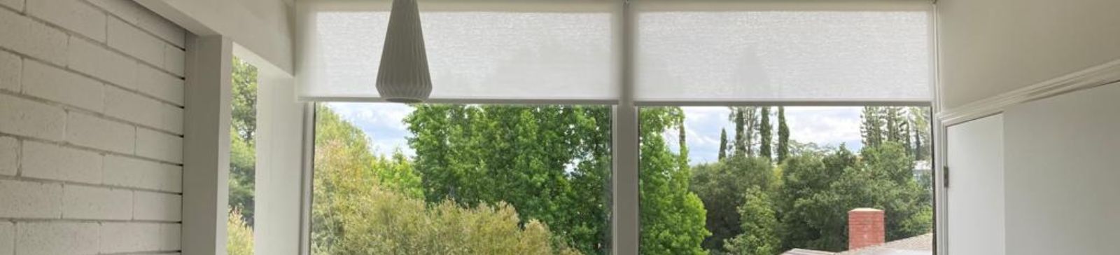 Sheer roller shades installed in a Mission Viejo condo kitchen, providing natural light while maintaining privacy.