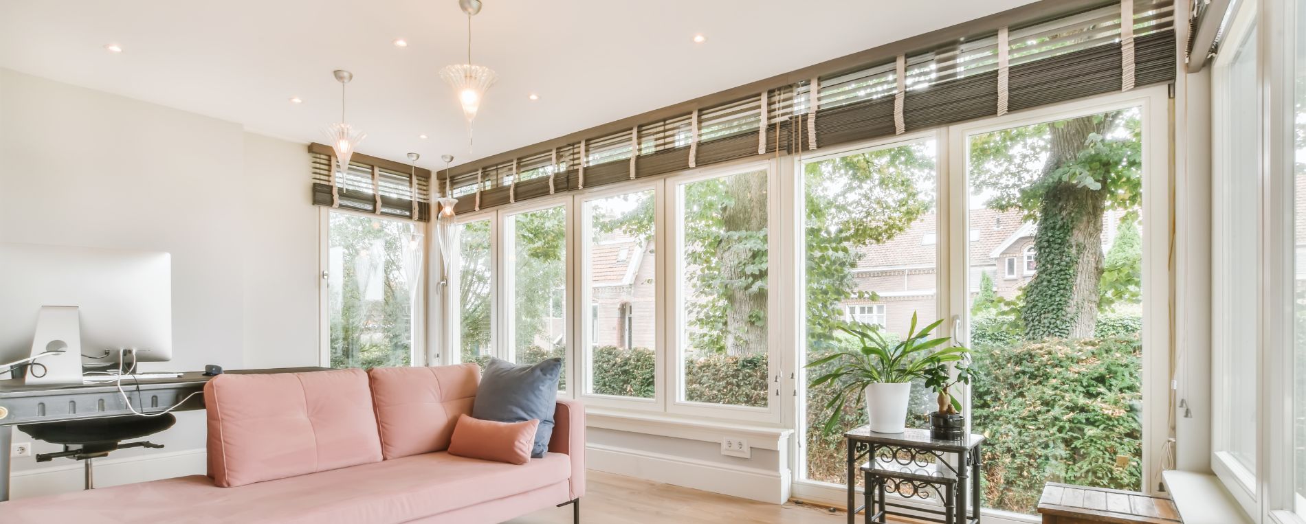 A view at a bright living room with a wooden blinds